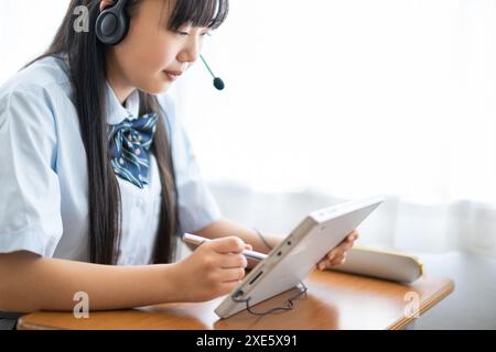Student taking a class using a tablet Stock Photo