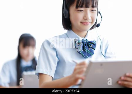 Student taking a class using a tablet Stock Photo