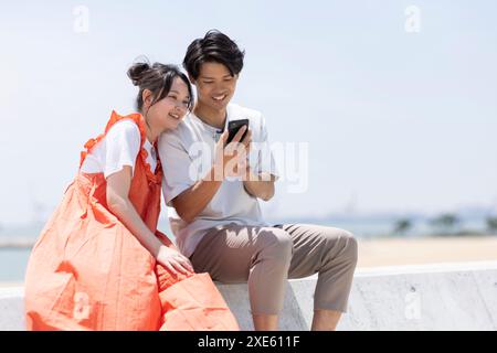 Man and woman looking at a smartphone Stock Photo