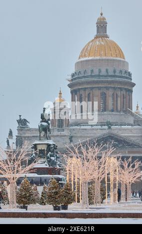 Russia, St Petersburg, 30 December 2023: people walk among Christmas trees in heavy snowfall, a park organized on holidays near Stock Photo