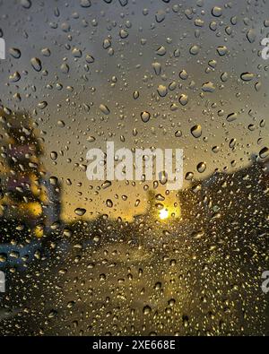 Raindrops on glass window at sunset. Wait rainy window Stock Photo