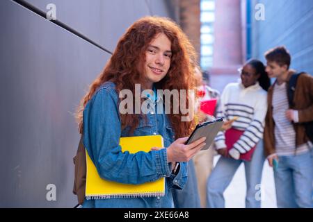 Young caucasian man browsing the internet using digital tablet outdoors. Stock Photo