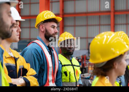 Portrait of engineers and industrial workers in hardhats at construction site Stock Photo