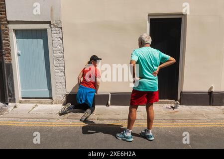 England, Kent, Deal, Man Talking to Woman doing DIY Stock Photo