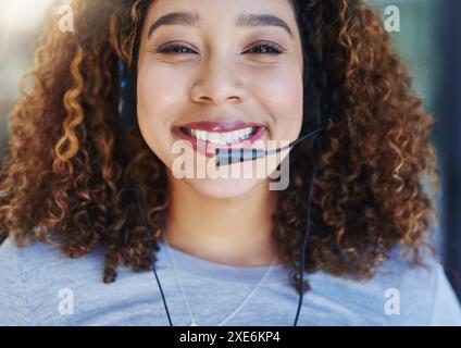 Black woman, portrait and happy in call center with headset for customer service, crm and consulting. Agent, headphones and communication with clients Stock Photo