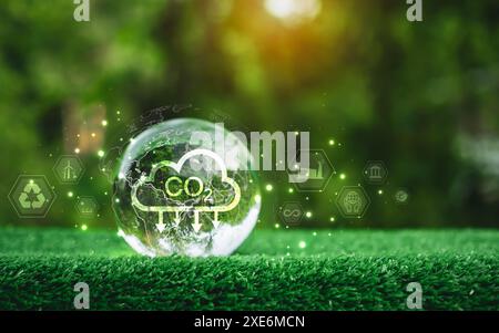 A glass sphere with a CO2 cloud on it, The sphere is surrounded by a green background with various icons and symbols, Scene is one of environmental aw Stock Photo