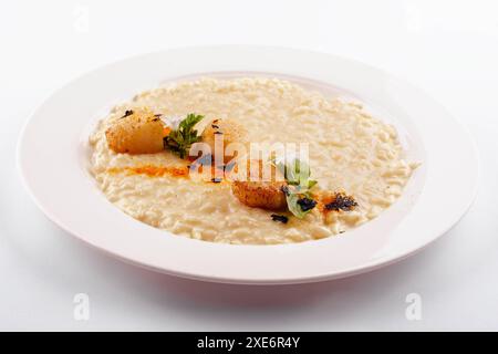 Scallops in sauce and white rice in a plate Stock Photo