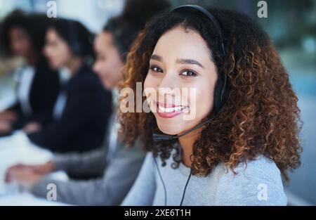 Black woman, portrait and smile in call center with headset for customer service, crm and help or consulting. Agent, headphones and talk with clients Stock Photo