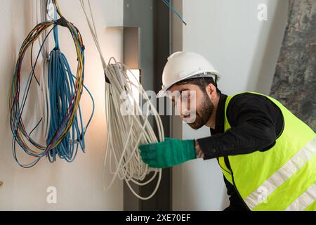 Engineers working on construction site, they are monitoring the building's electrical system. Stock Photo