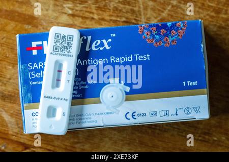 Positive COVID-19 test on a wooden table. Stock Photo