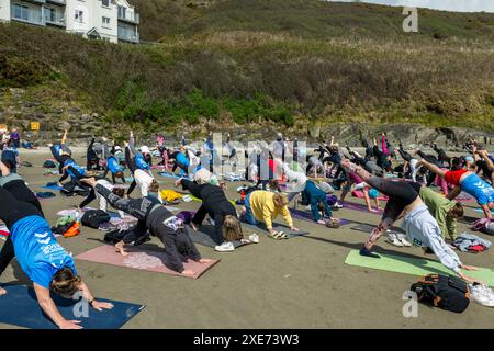 People doing a mass yoga fundraiser on Inchydoney Beach, West Cork, Ireland. Stock Photo