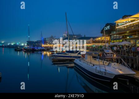 View of boats and restaurants in the Waterfront at dusk, Cape Town, Western Cape, South Africa, Africa Stock Photo