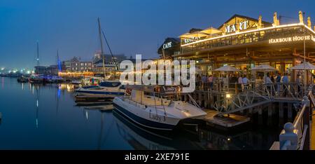 View of boats and restaurants in the Waterfront at dusk, Cape Town, Western Cape, South Africa, Africa Stock Photo