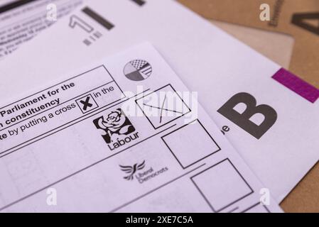 Postal vote with an X in the box for the Labour Party, for the 2024 UK General Election. Ballot paper voting Stock Photo