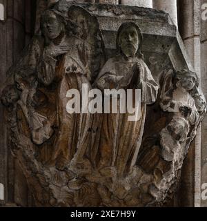 Biblical figures carved on corbel at base of niche on facade of the Stadhuis or Town Hall in the Grote Markt or Market Square at Leuven in Flemish Brabant, Flanders, Belgium.  The Stadhuis, built between 1439 and 1469, is a masterpiece of Flamboyant Gothic architecture and the elaborate carved niche bases or corbels are part of the building’s original 1400s design. Stock Photo