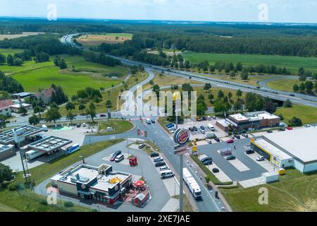 Thiendorf, Germany. 26th June, 2024. The Thiendorf industrial estate in the Meißen district with the McDonalds and Burger King fast food chains. Behind it the BAB13 highway. (Aerial view with a drone) Credit: Daniel Schäfer/dpa/Alamy Live News Stock Photo