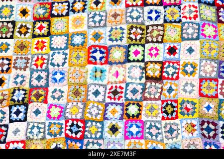 Multi colored blanket in wool, square geometric background, retro decorative pattern Stock Photo