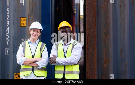 Portrait of two workers standing with arms crossed in front of container Stock Photo