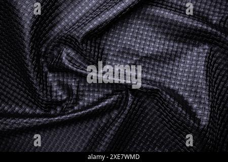 black vegan leather with pattern, fake crumpled textile texture Stock Photo
