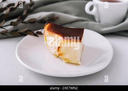 San sebastian cheesecake on plate with tea Stock Photo