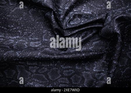 Vegan faux Snakeskin leather texture. minimalist and elegant crumple textile. simple dark black backdrop Stock Photo