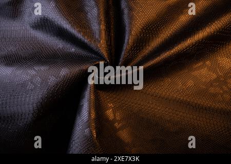 Vegan faux Snakeskin leather texture. minimalist and elegant crumple textile. simple dark black backdrop Stock Photo