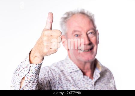 Senior Man Giving a Thumbs Up Gesture Stock Photo