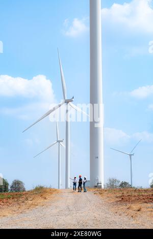 Team of engineers and architects working on wind turbines in a wind farm Stock Photo