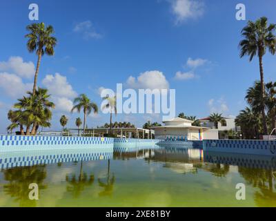 Drone aerial of abandoned deserted hotel swimming pool. Hotel is close for winter season. Dirty water abandoned place Stock Photo