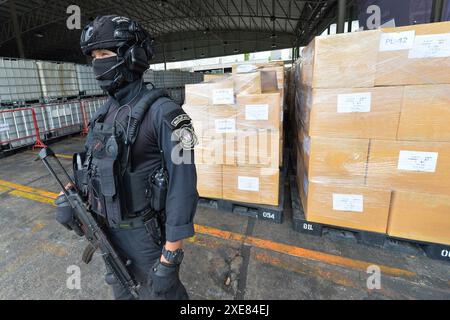 Bangkok. 26th June, 2024. A police officer stands guard in front of the illegal drugs to be burned at Bang Pu in Thailand's Samut Prakan Province, June 26, 2024. Thailand burned more than 20 tons of confiscated narcotic drugs worth 6.45 billion baht (about 175 million U.S. dollars) on Wednesday to mark the International Day Against Drug Abuse and Illicit Trafficking, authorities said. Credit: Rachen Sageamsak/Xinhua/Alamy Live News Stock Photo