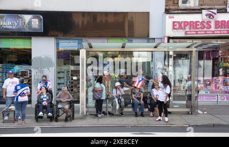 Neighborhood Puerto Rican Day Parade on 5th Avcenue in Sunset Park, Brooklyn, New York.  Local spectators at the event.   Local spectators at the event. Stock Photo