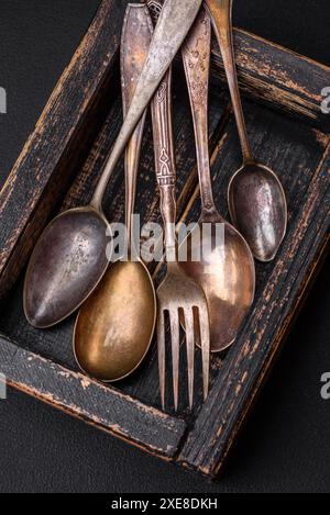 Vintage rectangular shabby wooden box with spoons and forks Stock Photo