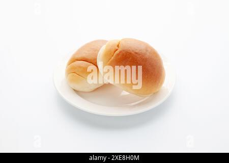 butter bread table rolls on plate isolated on white background Stock Photo