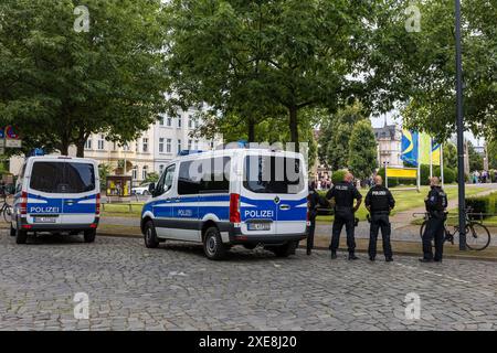 Cottbus, Germany. 26th June, 2024. Police officers stand at the Cottbus State Theater. A ceremony is being held here today to mark the 110th anniversary of the Carl-Thiem-Klinikum Cottbus under the motto 'Tradition meets the future'. The 'Vereinigte Städtische und Thiemsche Heilanstalt' was inaugurated on June 27, 1914. Credit: Frank Hammerschmidt/dpa/Alamy Live News Stock Photo