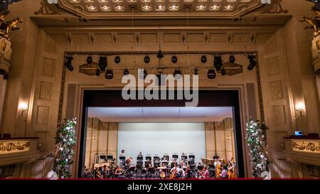 Cottbus, Germany. 26th June, 2024. Musicians rehearse in the main hall of the Cottbus State Theater for their performance at the ceremony to mark the 110th anniversary of the Carl-Thiem-Klinikum Cottbus under the motto 'Tradition meets future'. The 'Vereinigte Städtische und Thiemsche Heilanstalt' was inaugurated on June 27, 1914. Credit: Frank Hammerschmidt/dpa/Alamy Live News Stock Photo