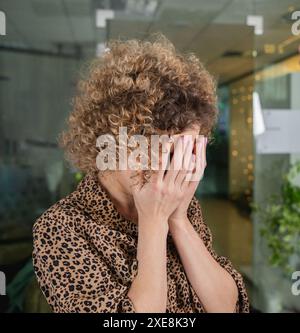 Desperate young woman in office Stock Photo - Alamy