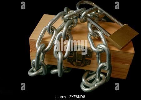 Wooden box tied with a chain and padlock Stock Photo