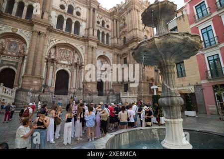 June 26, 2024, Malaga, Spain: Tourists are seen in front of Malaga cathedral at Plaza del Obispo square, amid a context of increasing rejection of mass tourism. Malaga has experienced significant growth in mass tourism and an increase in the number of tourist apartments in the city centre and neighborhoods. These factors have resulted in rising rental and housing prices. Local neighbourhood associations and organisations are calling for measures to be introduced to limit rental prices and the impact of mass tourism. (Credit Image: © Jesus Merida/SOPA Images via ZUMA Press Wire) EDITORIAL USAGE Stock Photo