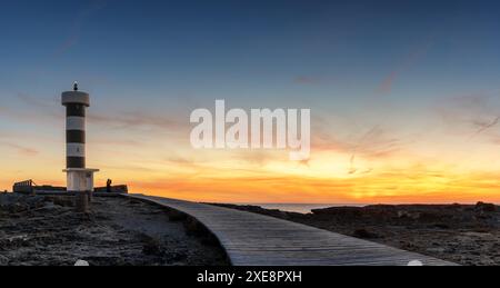 View of the lighthouse at Colonia Sant Jordi in Mallorca at sunset Stock Photo