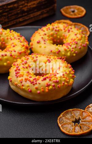Delicious fresh donuts in yellow glaze with lemon flavor filling Stock Photo