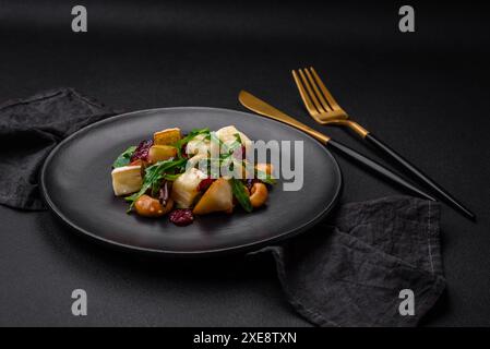 Delicious fresh vegan salad with pear, brie cheese, nuts and grains, and arugula Stock Photo