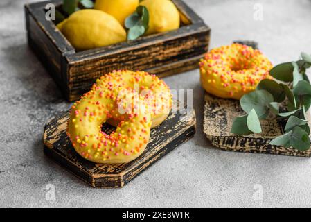 Delicious fresh donuts in yellow glaze with lemon flavor filling Stock Photo