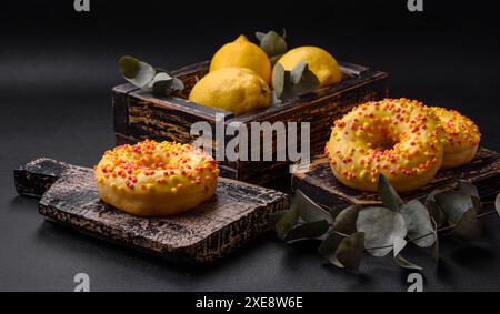 Delicious fresh donuts in yellow glaze with lemon flavor filling Stock Photo