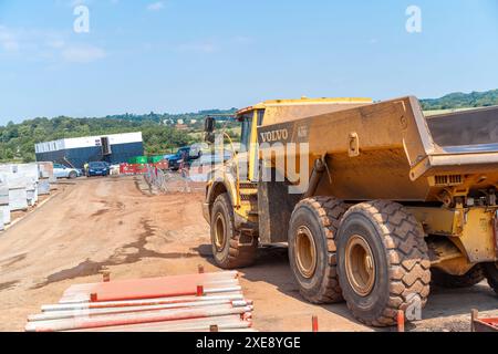 Construction site vehicles on a new build building site. Rear view of a large Volvo dumper truck. Stock Photo