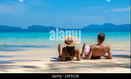 Koh Wai Island Thailand tropical Island near Koh Chang, couple of men and woman laying on the beach Stock Photo