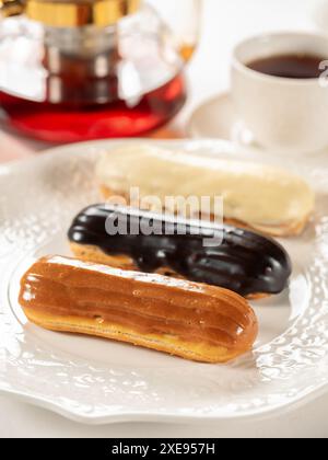 Group of french dessert Eclair on white plate Stock Photo