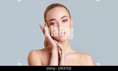 Woman With Light Brown Hair Posing With Hands on Face Stock Photo