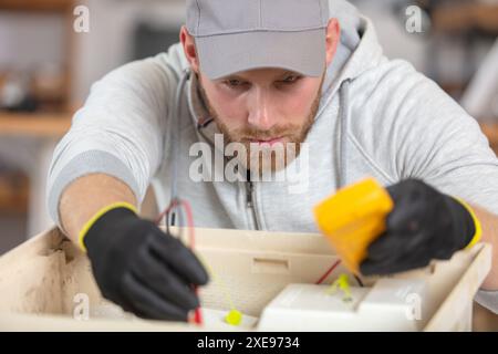 electrician installing energy saving meter Stock Photo