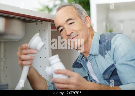 man fixing pipes at home Stock Photo
