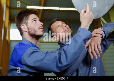 portrait of two engineers gesturing together Stock Photo